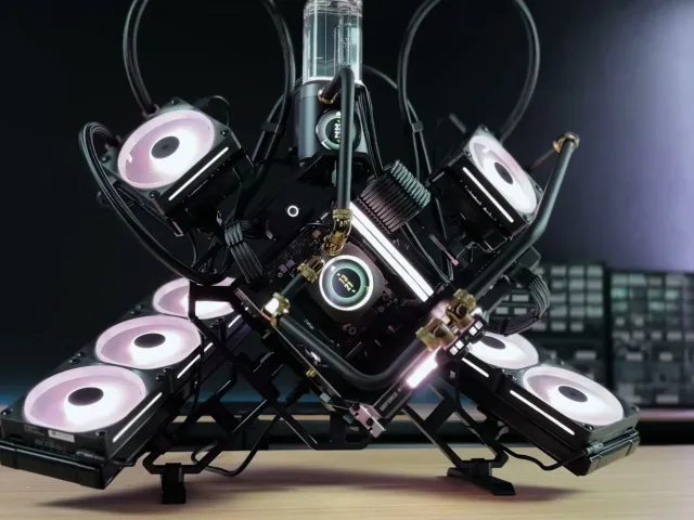 An open-air water-cooled PC with brass fittings and white fans
