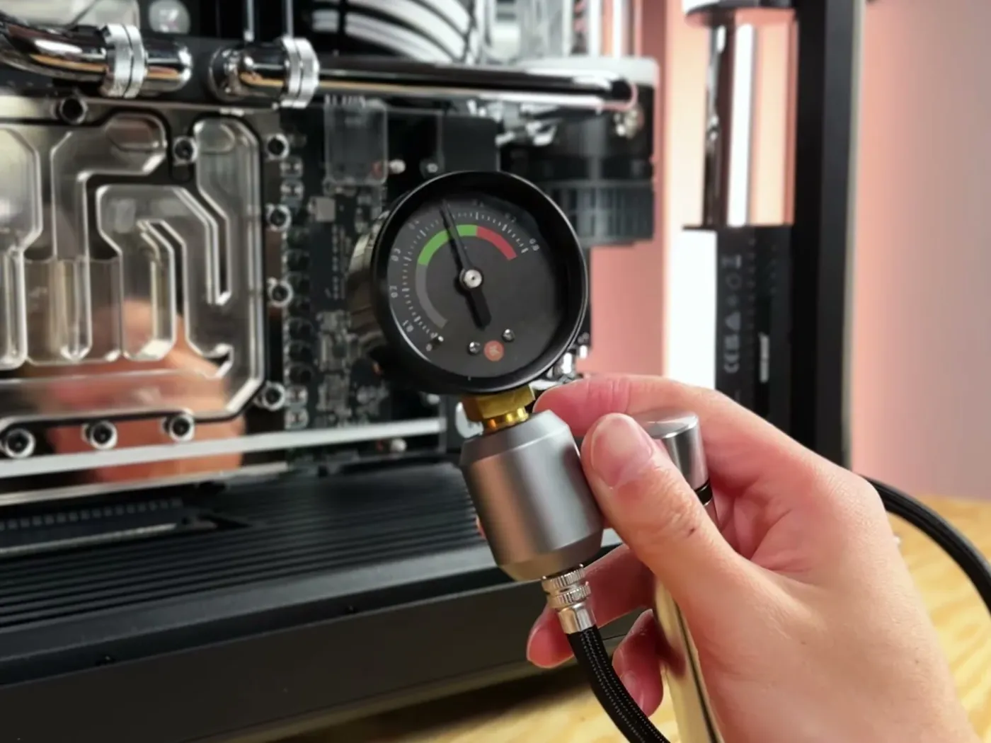 A pressure gauge connected to a water cooling loop during a leak test
